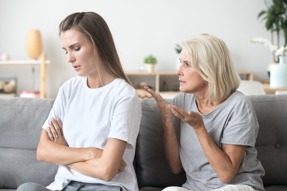 Upset adult daughter ignoring not listening to senior old strict mother in law arguing moralizing scolding controlling showing authority to stubborn young woman, different generation conflict concept