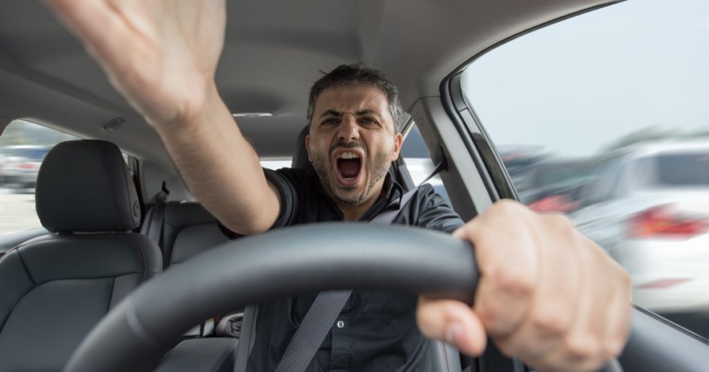 Angry man driving a vehicle