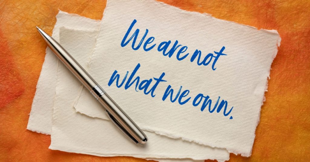 We are not what we own - inspirational handwriting on a handmade paper, simplicity, minimalism, lifestyle and anti consumerism concept