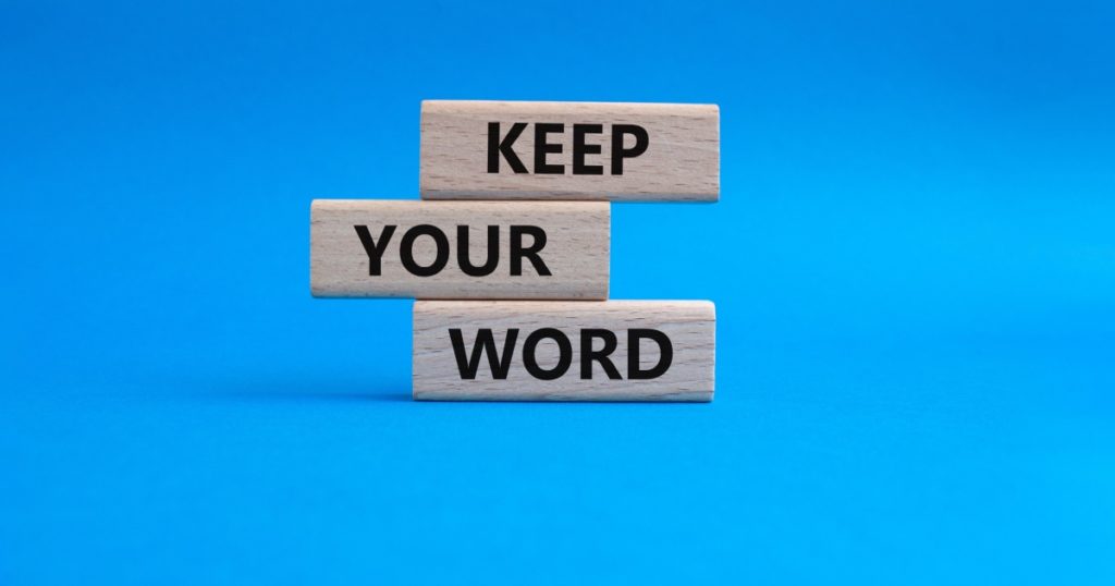 Keep your word symbol. Wooden blocks with words Keep your word. Beautiful blue background. Business and Keep your word concept. Copy space.