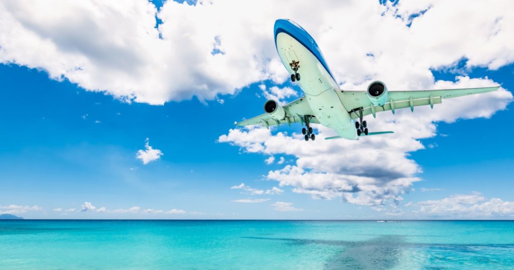 Plane at Maho beach in St Maarten. Travel and air transportation background.