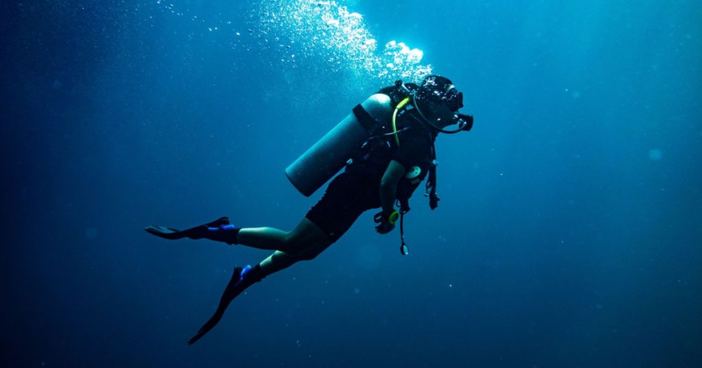 Scuba diving safety stop performed in the deep blue sea