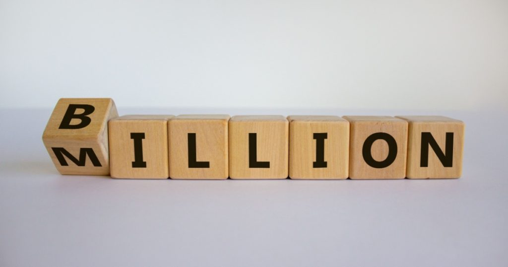 Turned a cube and changed the expression 'million' to 'billion'. Beautiful white background. Copy space. Business concept.