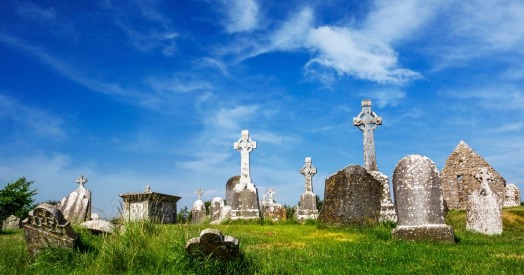 Clonmacnoise Cathedral with the typical crosses and graves. The monastery ruins. Ireland