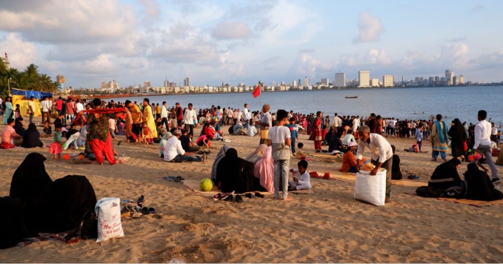 Mumbai, Maharashtra, Indiai, October 02, 2022 - Visitors enjoying at Girgaon Chowpatty beach on Sunday evening, a popular public beach along Marine Drive in Mumbai.