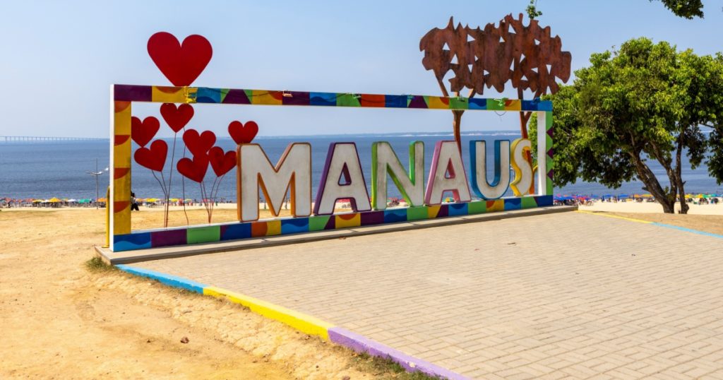 MANAUS written in big bright letters with colorful framing at Praia Ponta Negra, the Ponta Negra Beach, in the jungle metropolis Manaus in the heart of the Amazon rainforest of Brazil, South America