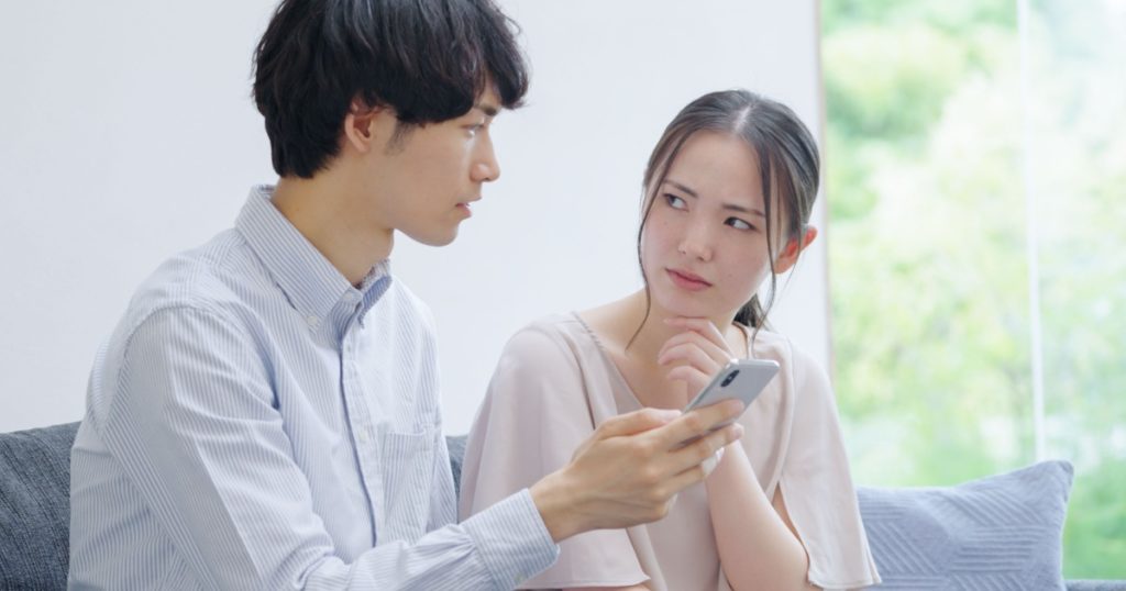 Asian young couple looking at a smartphone