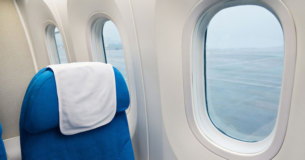 The Mystery of the Triangle Stickers Above Airplane Seats—What Do They Really Mean? - Featured image