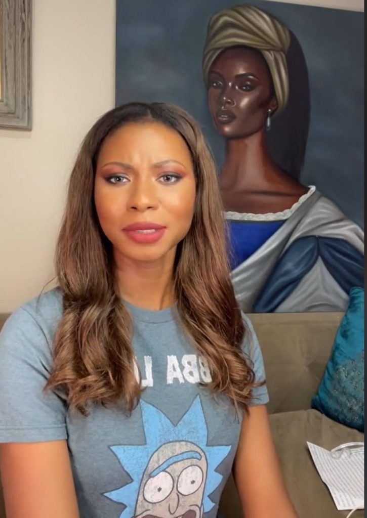 A woman speaking in front of a large portrait regarding her theory on the afterlife. 