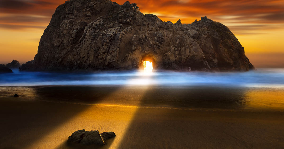 sunset shining through rock