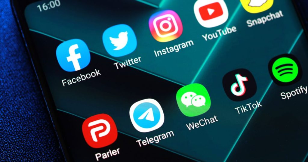 Soft focus image of android phone with icons for Parler and Twitter to illustrate dispute over the banning of President Trump account.