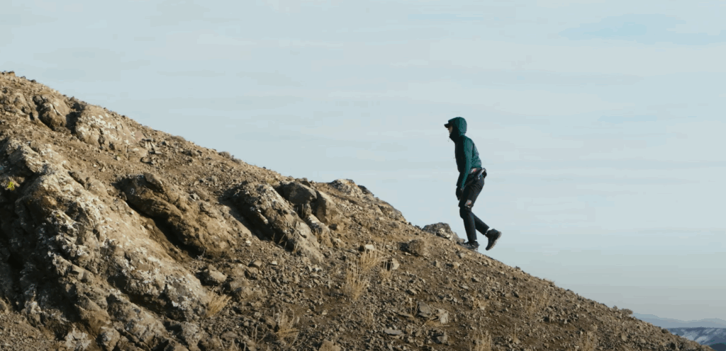 man climbing hill