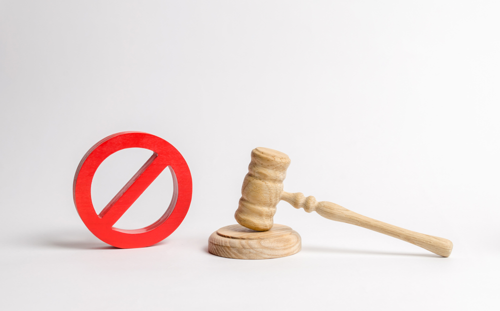 Judge's gavel and NO symbol. The concept of prohibiting and restrictive laws. Prohibitions and criminalization, repression, restriction of freedoms and rights of people and citizens.
