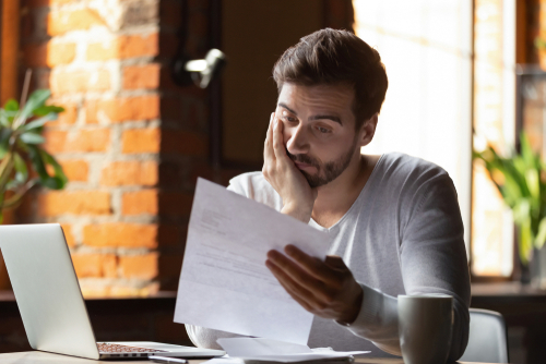 Confused frustrated young man reading letter in cafe, debt notification, bad financial report, money problem, money problem, upset student receiving bad news, unsuccessful exam or test results