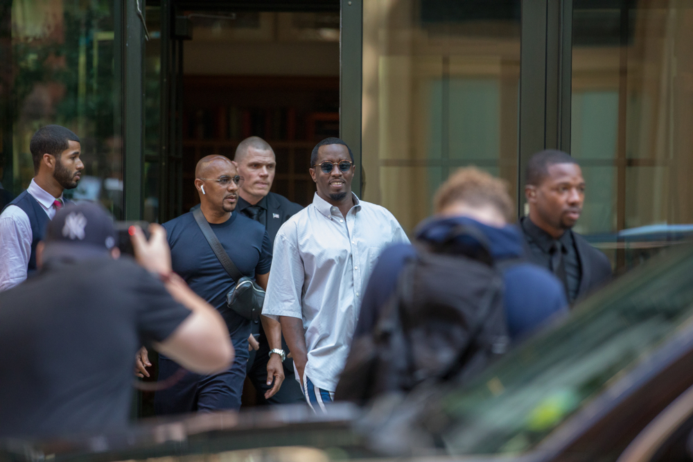 Lower Manhattan NYC, New York / USA - July 24, 2019: Sean “Diddy” Combs exiting the Crosby Street Hotel and heading to a waiting line of black SUV's surrounded by paparazzi and flanked by security.