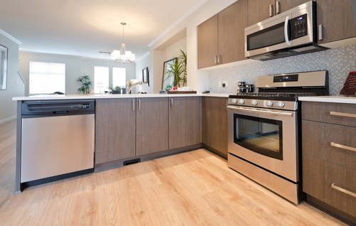 Interior design of a luxury modern kitchen with the living room at the back.