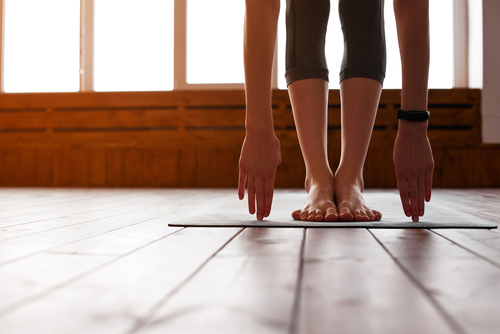 Close-up of young woman with exercise mat preparing for sports training