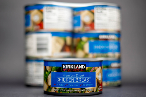 Fort Myers, Florida - USA -7-31-21: Cans of Kirkland Signature Premium Chunk Chicken Breasts advertising 13 g of Protein