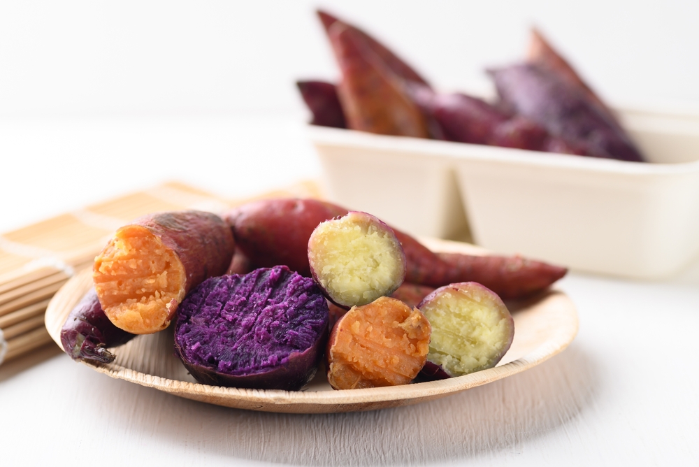 Sweet potatoes (Purple, orange and yellow) on white background