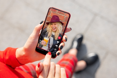 Woman viewing social media content on mobile phone