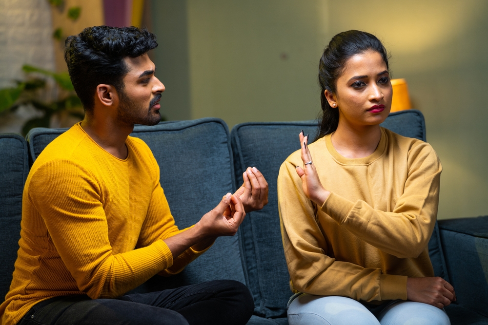 Girl or wife saying no husband trying to convince at home - concept of break up, conflict and disagreement