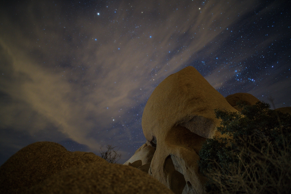 Skull Rock in Joshua Tree National Park with Orion. Some may see an alien skull, others might perceive a ghoulish shape in the form of a shadow person. Pareidolia at play.