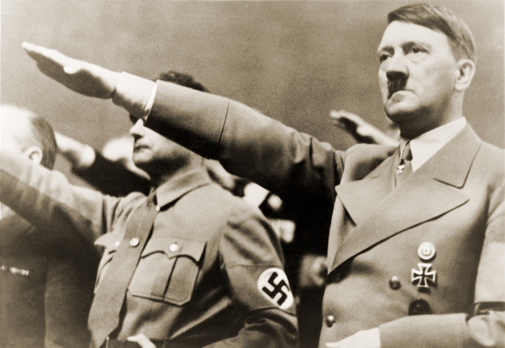 Adolf Hitler, giving Nazi salute. To Hitler's right is Rudolph Hess. 1939.