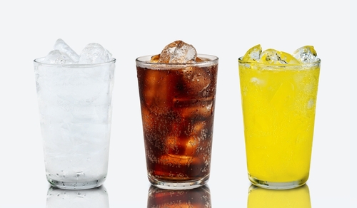 Set of cold soft drink difference flavor in tall glass cola, soda water, orange flavor in tall glass isolated with reflection on white background.