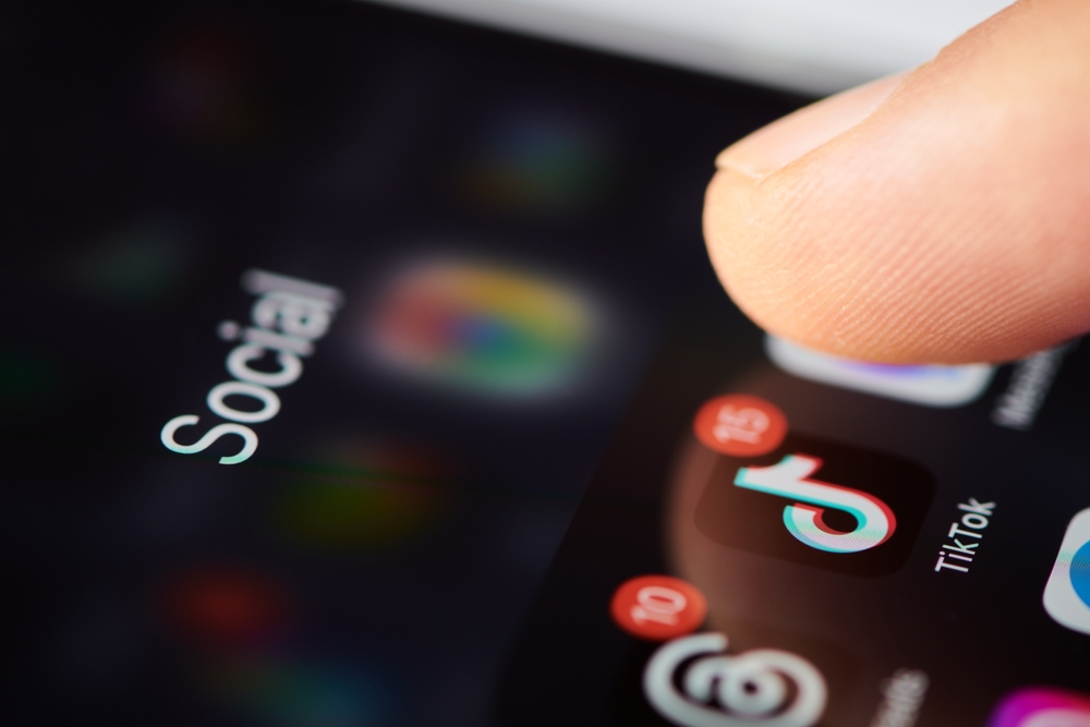 TikTok app icon on smartphone screen with other social media apps. Finger touch the icon of the TikTok application to run. Short video social blogging. Shallow DOF, Moscow, Russia