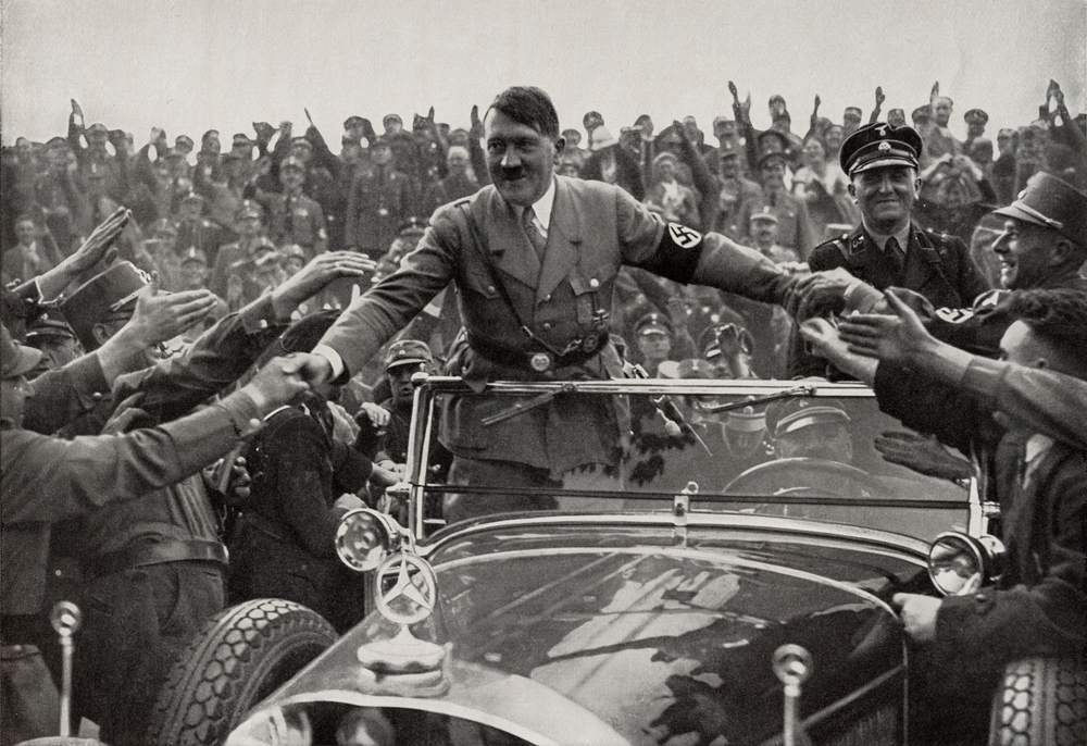 Nuremberg, Germany - August 9, 2024: Old published photo from the 1930s of Adolf Hitler, leader of Nazi Germany in Nuremberg with followers in 1933.