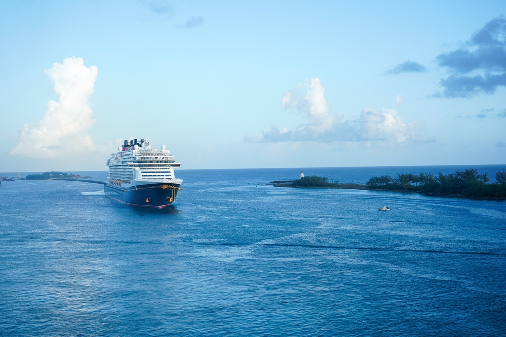 Large cruise ship entering the port at Nassau, Bahamas. Ocean, lighthouse, beautiful scenery.