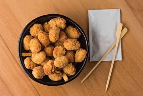 Crispy Chicken Popcorn with Dipping Sauce served in plate isolated on wooden table top view fast food snacks