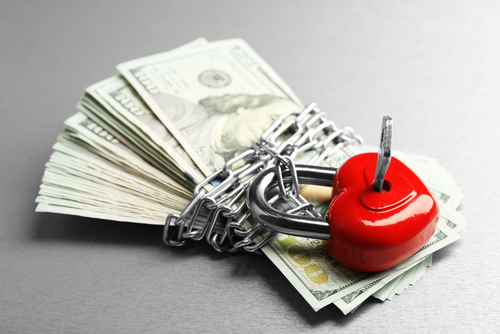 Dollars currency with lock and chain on gray background