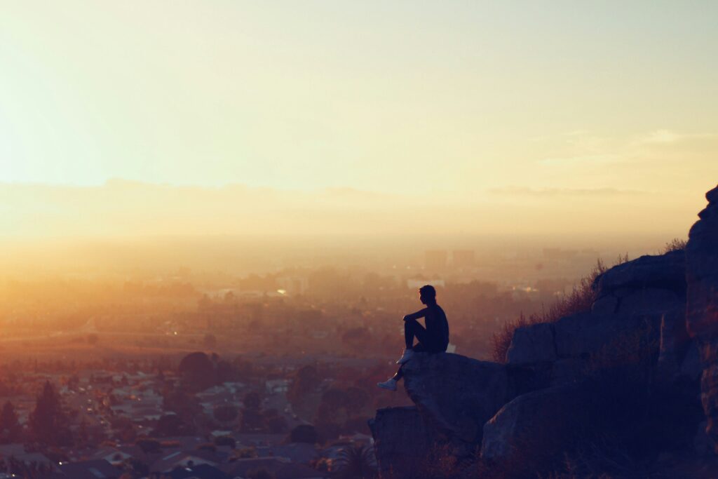 man sitting on rock