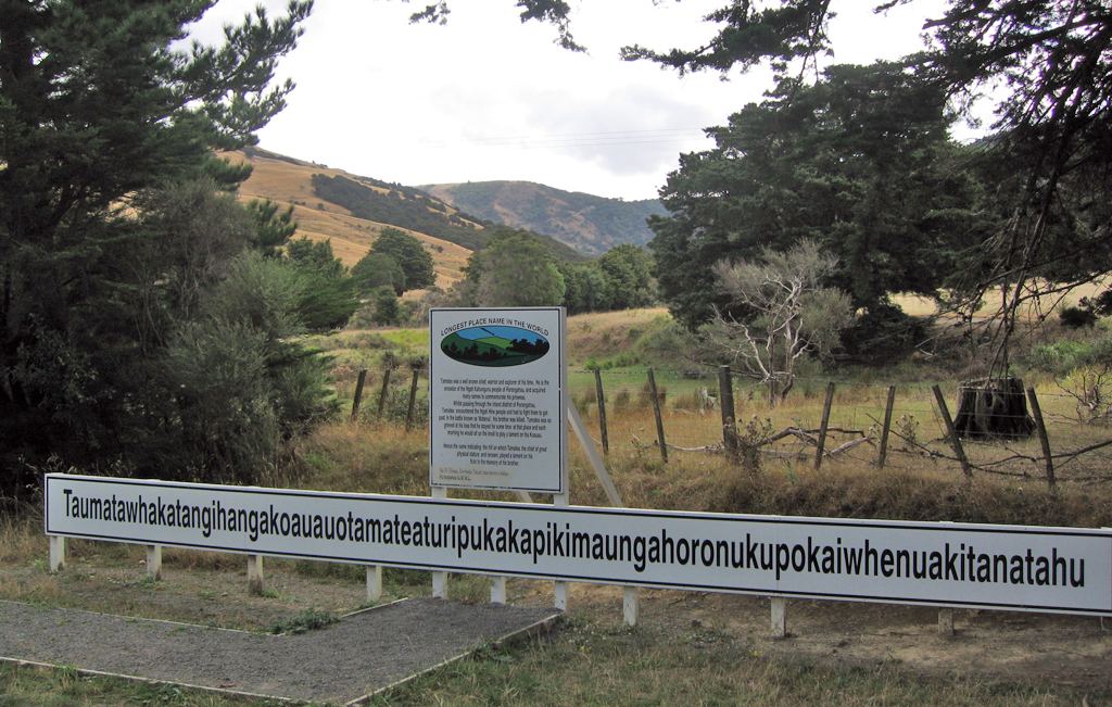 Sign on Wimbledon Road for the hill named Taumatawhakatangihangakoauauotamateaturipukakapikimaungahoronukupokaiwhenuakitanatahu. The hill is at centre in the far distance.