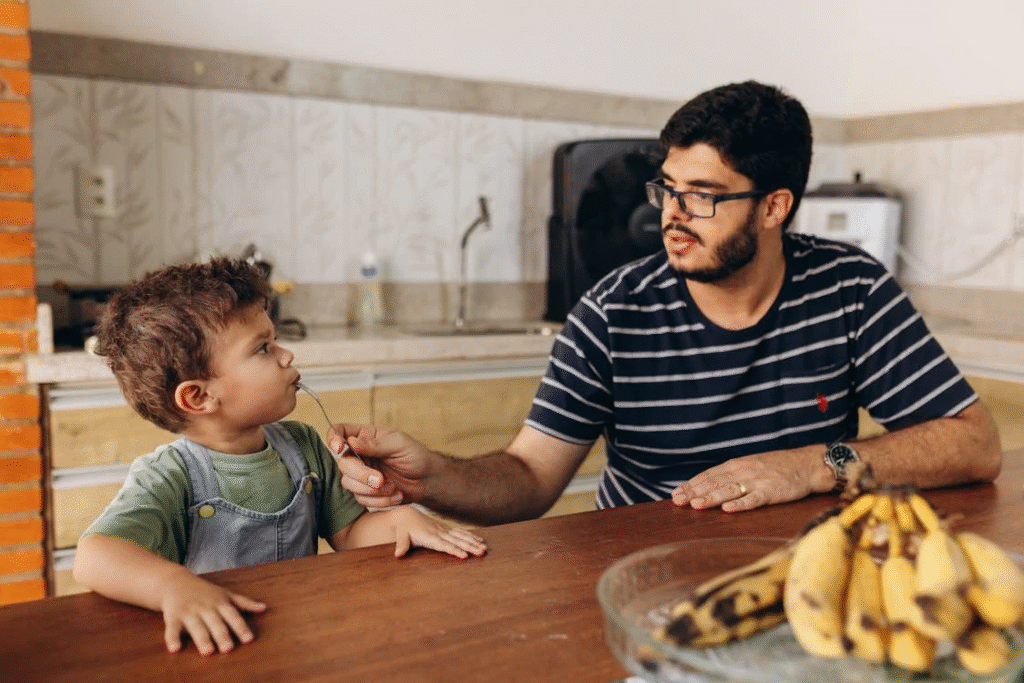 father feeding son