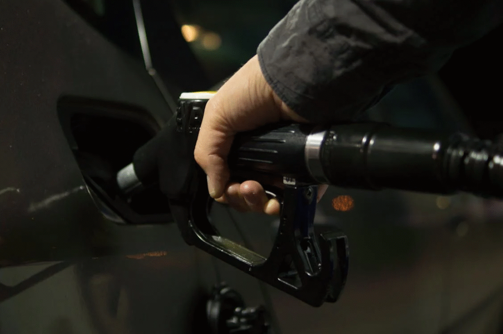 hand putting in gas