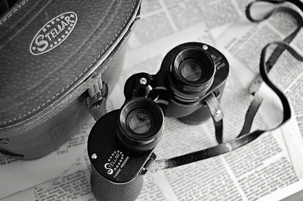 binoculars on newspaper