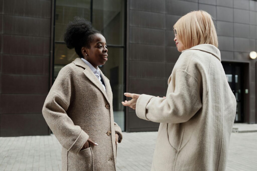 two women in coats talking