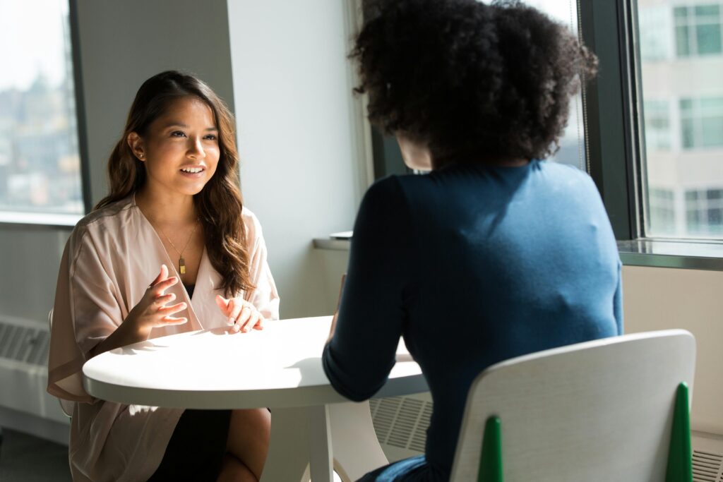 women sitting at table talking