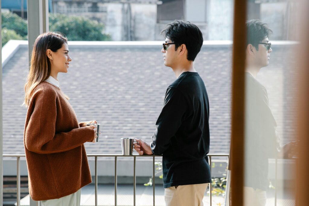 man and woman talking outside