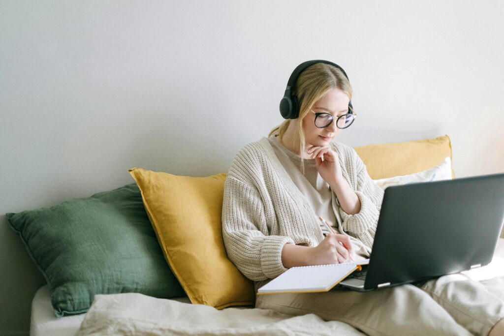 woman on laptop in bed