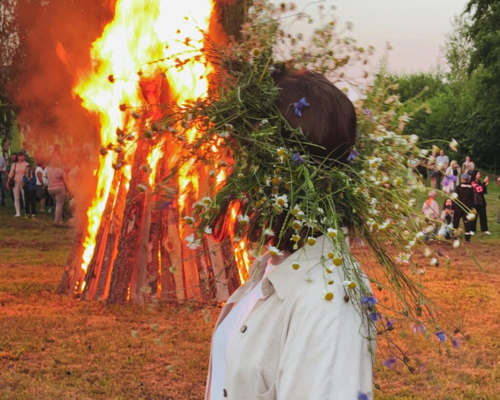 woman wearing flower crown at bonfire