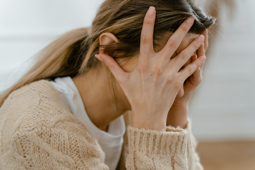 woman with hands on her head