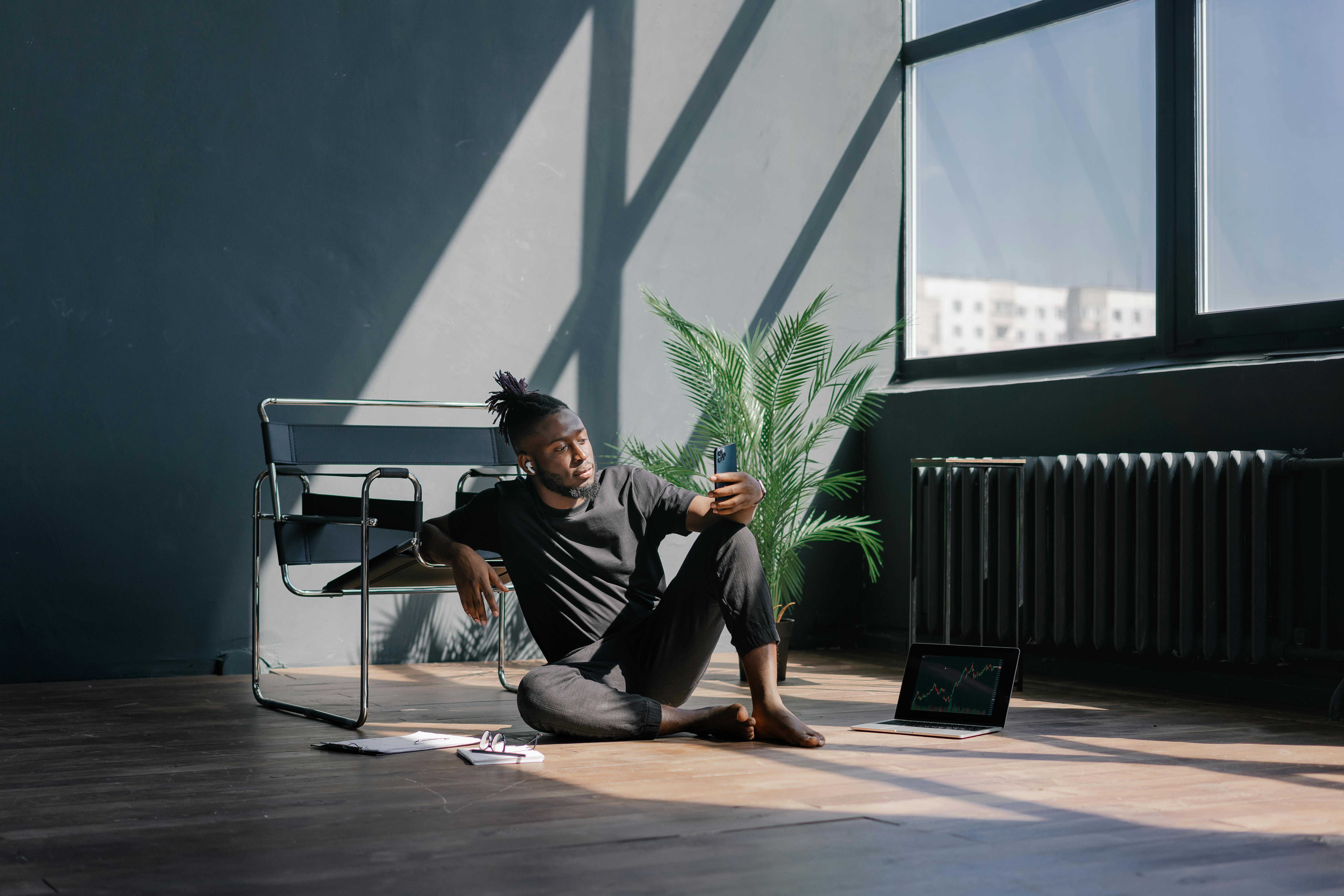 man in Black Shirt Sitting on Floor