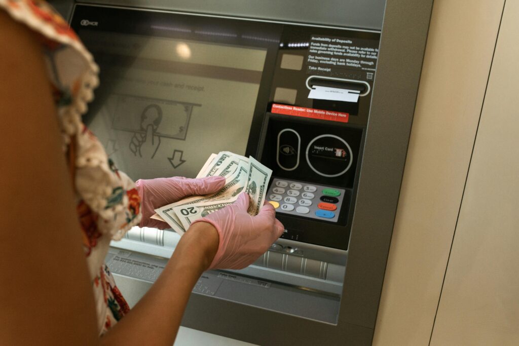 woman counting money at atm