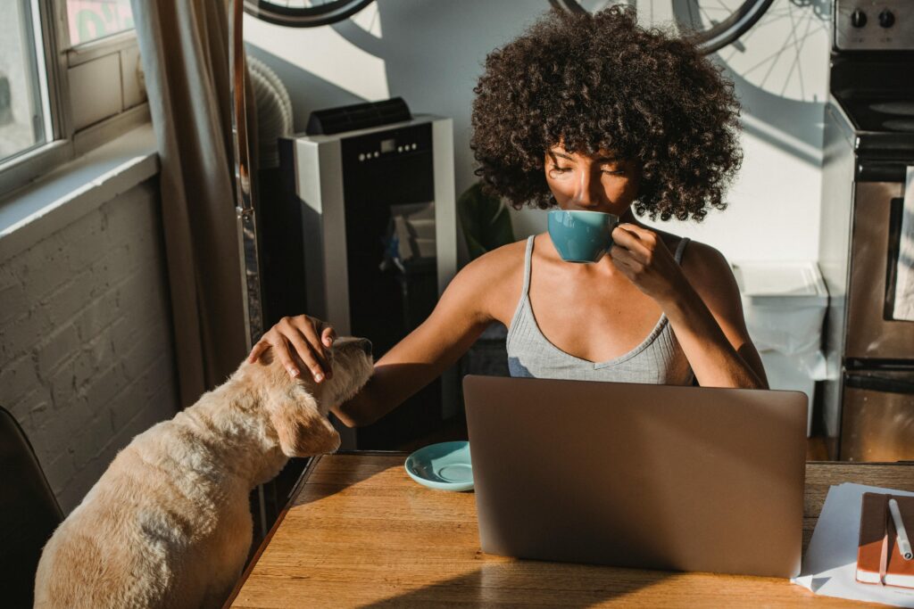 woman with dog at laptop