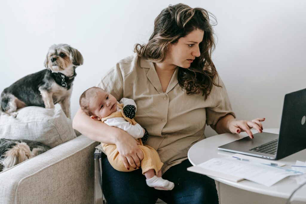 mother holding baby at laptop