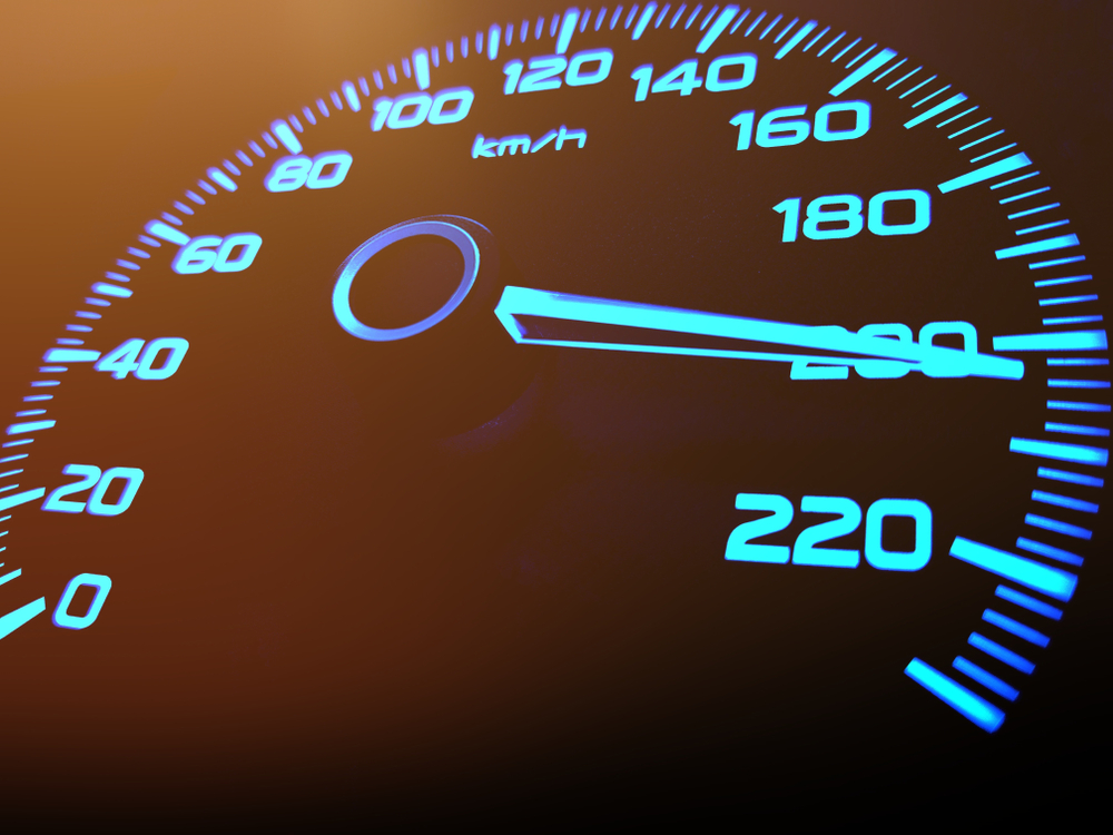 close up of car meter with black background