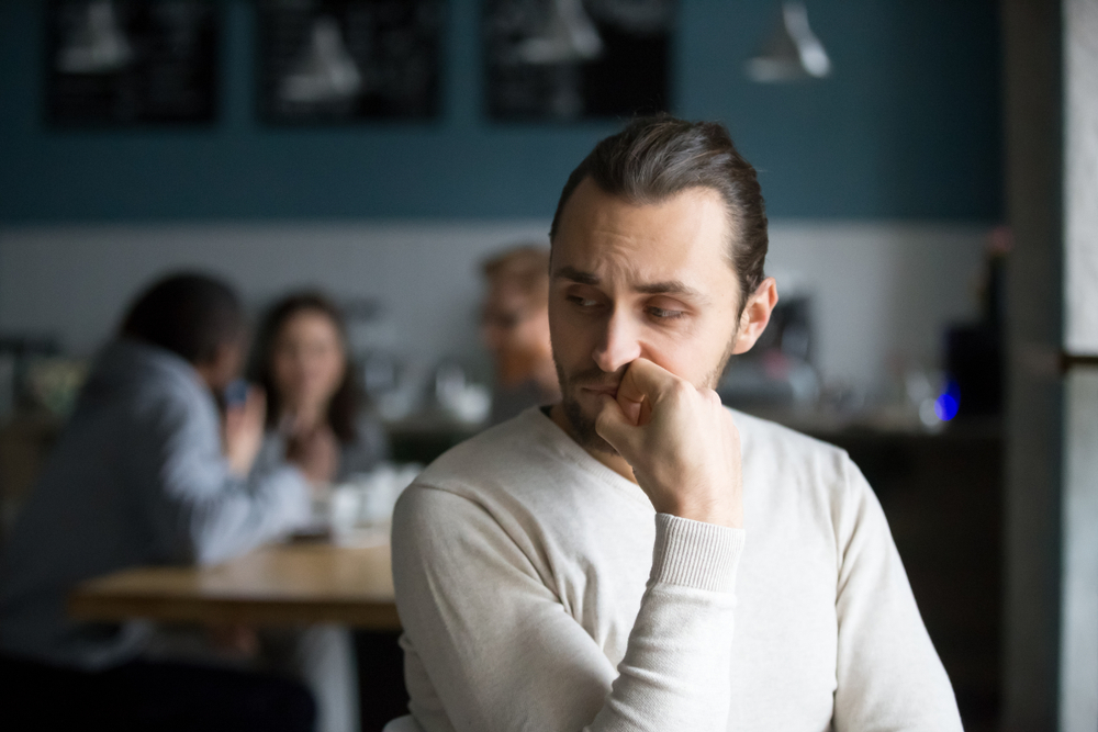 man sitting looking worried